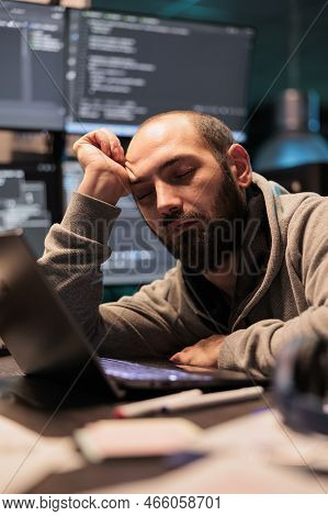 Tired It Enigneer Falling Asleep At Office Desk Working On Interface Programming, Holding Head With 
