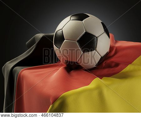 A Regular Soccer Balls Resting On A Germany Flag Draped Over A Plinth On An Isolated Studio Backgrou