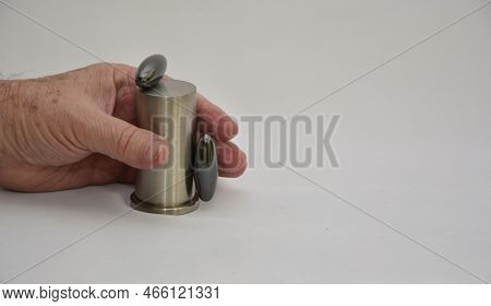 A Man's Hand Holding A Stainless Steel Bar With Two Magnet Or Magnet Units. White Background. Copy S