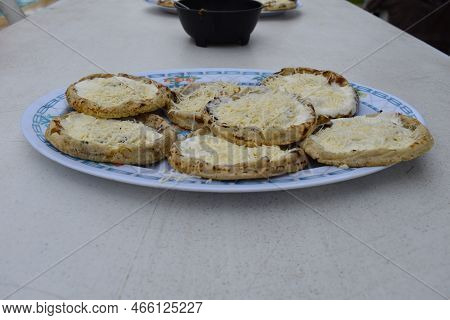 A Plate Of The Mexican Dish Called Sopes Or Picadas, On A White Table, Food