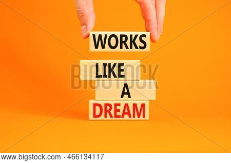 Works Like A Dream Symbol. Concept Words Works Like A Dream On Wooden Cubes. Beautiful Orange Table 