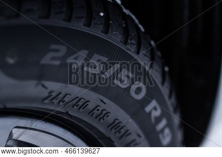 Close Up View Of Snowy Tire With Tire Width, Height And Wheel Diameter Designation. Winter Tire Size