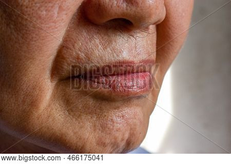 Skin Folds And Creases In Face Of Asian Elder Man.