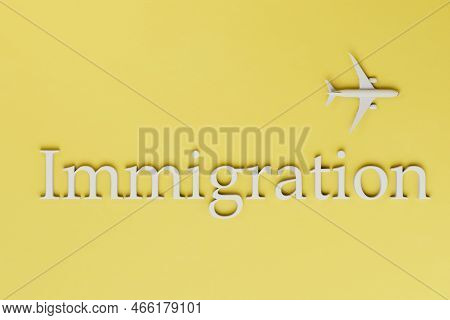 The Concept Of The Emigration Process. A Flying Plane And The Inscription Emigration On A Yellow Bac