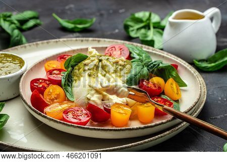 Traditional Italian Dish Burrata Cheese With Glass Of Rose Wine. Burrata Served With Tomatoes And Gr