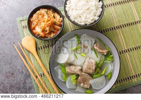Korean Food Beef Radish Soup Which Is Called Soegogi Muguk Served With Rice And Kimchi Closeup On Th