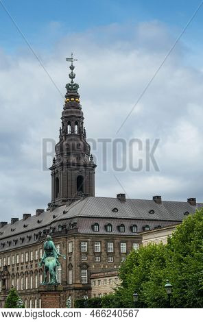 Copenhagen, Denmark - July 23, 2022: Absalon On His Horse Green Bronze Statue Looks At Gray Stone Ch