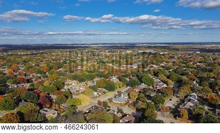 Aerial View Suburban Residential Neighborhood Under Cloud Blue Sky With Colorful Fall Foliage And Ro