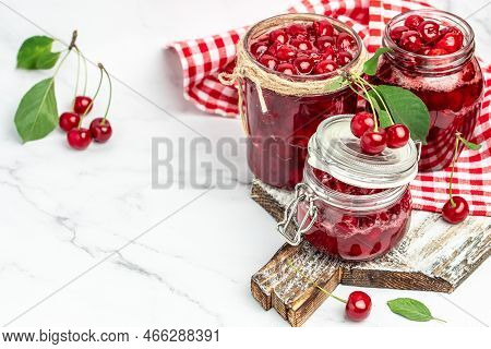 Jar Of Cherry Jam And Sour Cherries. Berries Cherry With Syrup. Ripe Ripe Cherries. Sweet Red Cherri