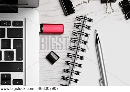 Modern Usb Flash Drive Attached Into Laptop, Notebook And Pen On White Wooden Table, Flat Lay
