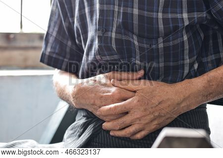 Asian Elder Man Suffering From Abdominal Pain. It Can Be Caused By Stomach Ache, Enteritis, Colitis,