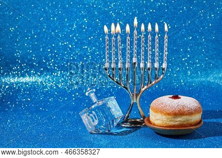 Jewish Holiday Hanukkah Background With Menorah And Dreidel With Letters Gimel And Nun.