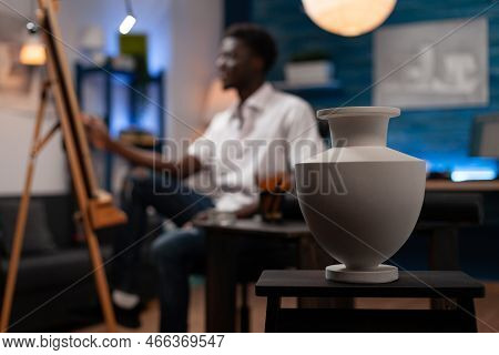African American Artist Creating Professional Sketch Of Ceramic Vase On Easel In Modern Art Studio. 