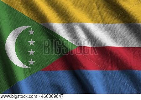 Comoros Flag With Big Folds Waving Close Up Under The Studio Light Indoors. The Official Symbols And