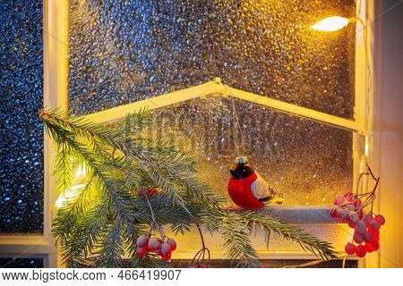Christmas Decor With Branch Of Fir, Red Berry,  Bird Feeder With Bulfinch On Glass Door