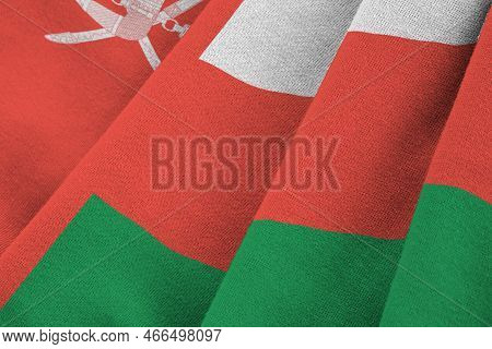 Oman Flag With Big Folds Waving Close Up Under The Studio Light Indoors. The Official Symbols And Co