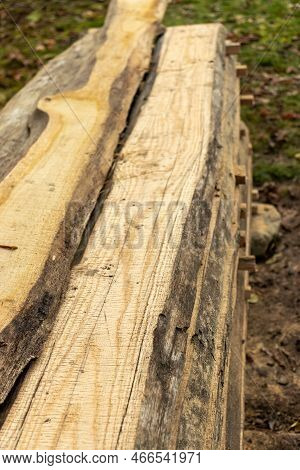 Piled Lumber Near A Lumber Mill. Lumber And Wood Slice. Stacked Lumber. Folded Wood.closeup Wooden B