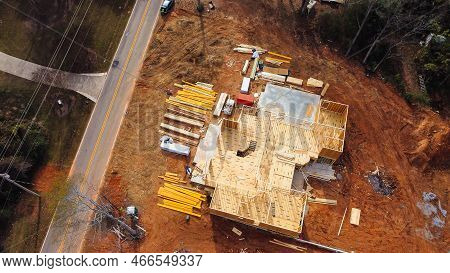 Wooden House Under Construction With Framing Of Beams And Rafters, Joints, Trusses In Residential Ne
