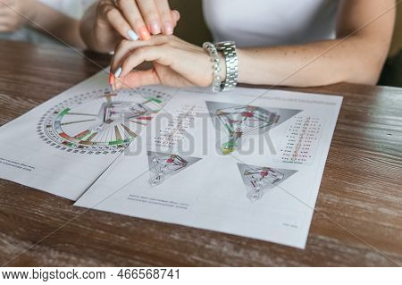 Tver, Russia - August 2, 2021. A Woman In A Cafe At A Table Is Studying The Design Of A Person. The 