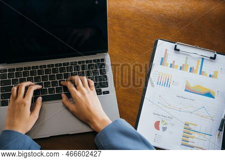 Professional Business Woman Working On Laptop Computer With Chart Graphs And Calculator On Desk In O