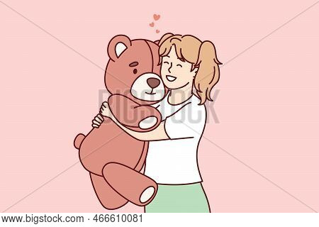 Little Girl Hugs Big Favorite Soft Toy And Smiles Feeling Affection. Happy Preschool Child Holding P