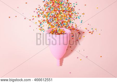 Pink Menstrual Cup And Bright Beads Like Menstrual Blood Drops With Shadow On Pink Background. Women