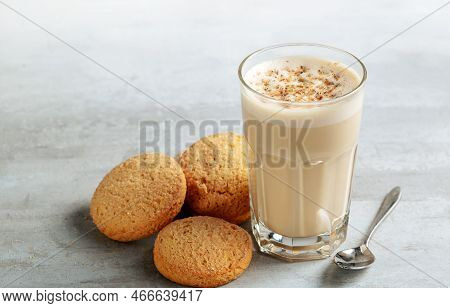 Coffee Raff In A Glass Close-up With Homemade Cookies. Coffee With Milk And Grated Nut On Light Back