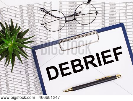 Folded Business Papers, Pen, Glasses, A Flower In A Pot And A Tablet With A Sheet Of Paper With The 