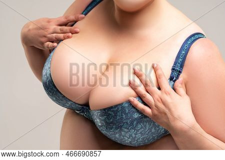 Big Natural Breasts In Blue Bra Close-up, Biggest Boobs On Gray Background