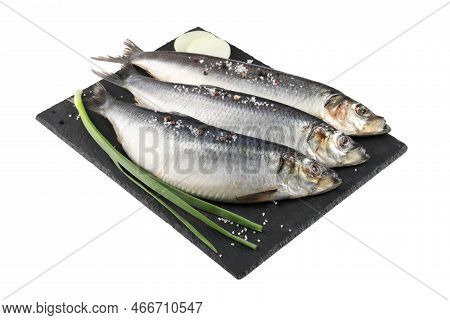 Slate Plate With Salted Herrings, Spices And Onion Isolated On White