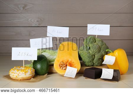 Food Products With Calorific Value Tags On Wooden Table. Weight Loss Concept