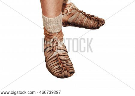 An Ancient Roman Man Legs In Caligae Leather Sandals, Isolated On A White Background. Reconstruction