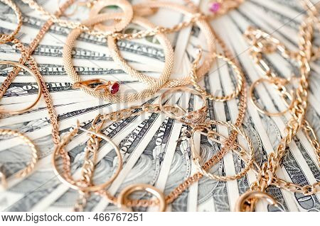 Many Expensive Golden Jewerly Rings, Earrings And Necklaces On Big Amount Of Us Dollar Bills Close U