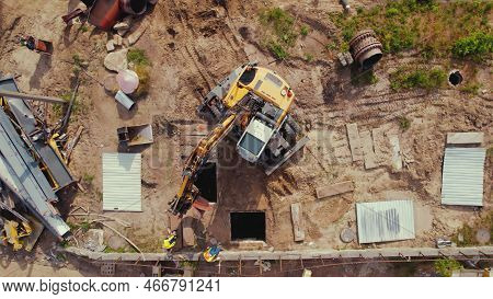 06.07.2022 Warsaw, Poland - Demolition Construction Working Site. An Excavator Performing Lifting Op