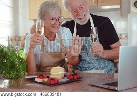 Beautiful Senior Couple In The Home Kitchen After Baking Their Homemade Plumcake They Hold Two Glass