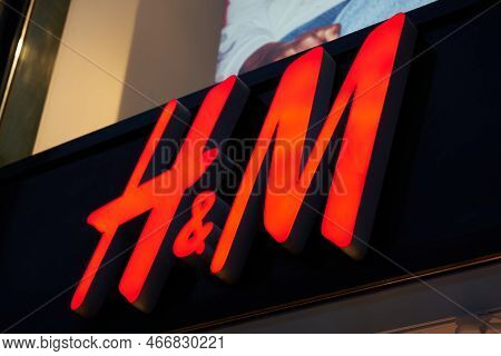 Berlin, Germany - May 26, 2022: Illuminated Advertisement Of The Swedish Textile Retailer H&m, Henne