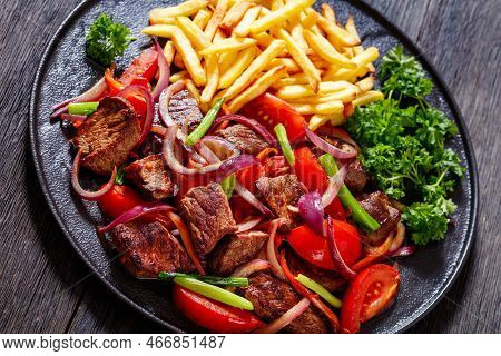 Lomo Saltado, Peruvian Dish Of Stir-fried Slices Of Beef Sirloin, Onions, Yellow Peruvian Chilis, An