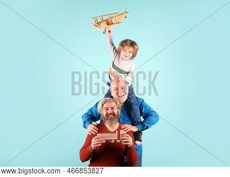 Boy Son With Father And Grandfather With A Toy Airplane Plays On Isolated Background.