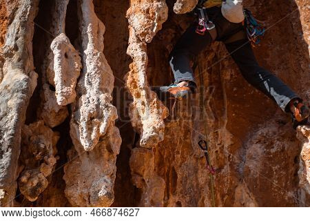 A Young Man With Climbing Equipment, In Rock Shoes, With A Rope, Magnesia, Climbs The Mountain Up, I