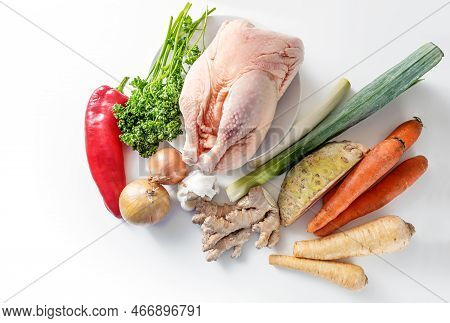 Raw Ingredients For A Healthy Chicken Broth Against Cold And Flu With Root Vegetables, Leek, Ginger,