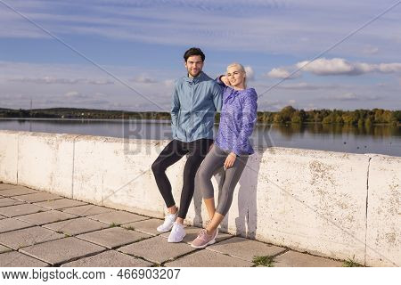 Jogging Concepts. One Positive Runners  Couple Posing Together At River Bank Outside As Runners Duri