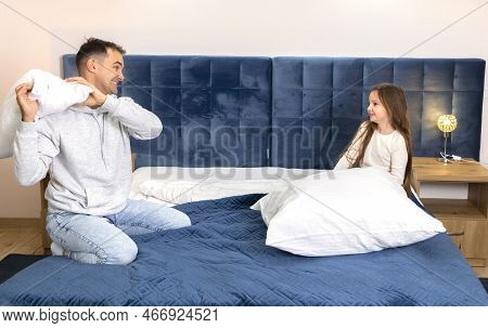 Father Plays With Child, Dad Having Pillow Fight With Daughter In Bed At Home.happy Family.horizonta