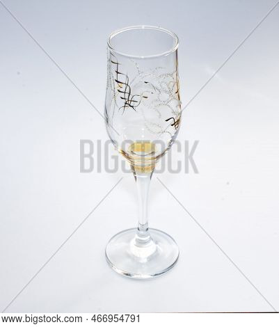 A Fuger Or A Glass Of Champagne Stands On A White Background.