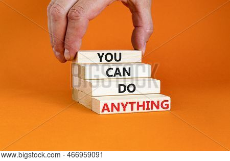 You Can Do Anything Symbol. Concept Word You Can Do Anything On Wooden Blocks. Businessman Hand. Bea