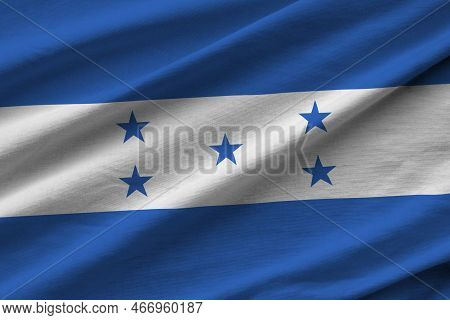 Honduras Flag With Big Folds Waving Close Up Under The Studio Light Indoors. The Official Symbols An