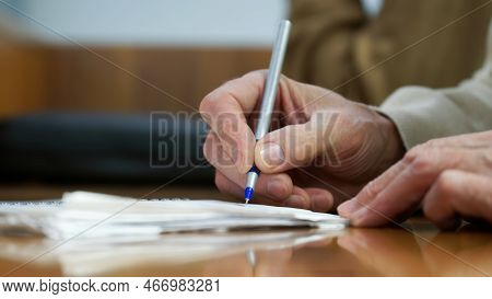 The Hand Of An Adult Man With A Fountain Pen, Writing In A Notebook. No Face. Selective Focus. Close