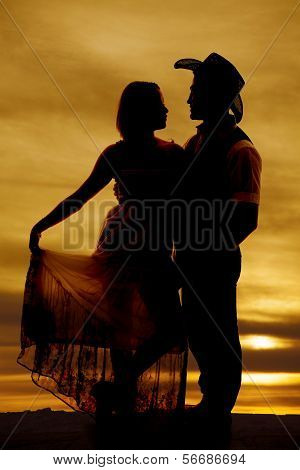 Silhouette Cowboy Couple Hold Dress Facing