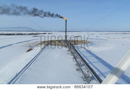 Torch system on an oil field
