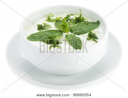 Traditional Turkish appetizer diced cucumber, garlic and mint in yoghurt, called cacik isolated on white background.