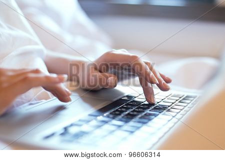 Image of girl's hands typing. Selective focus